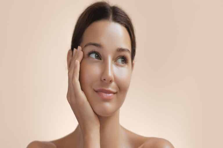 A woman touching her cheek after a SKNLAB facial in Navarre