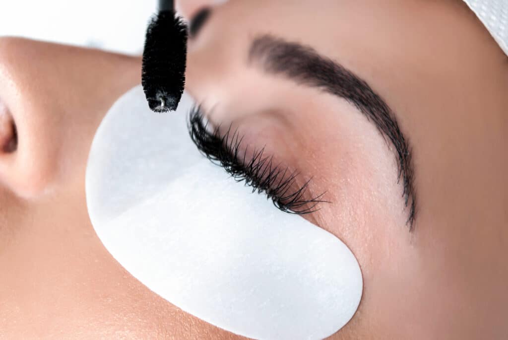 Woman's closed eye during eyelash tinting